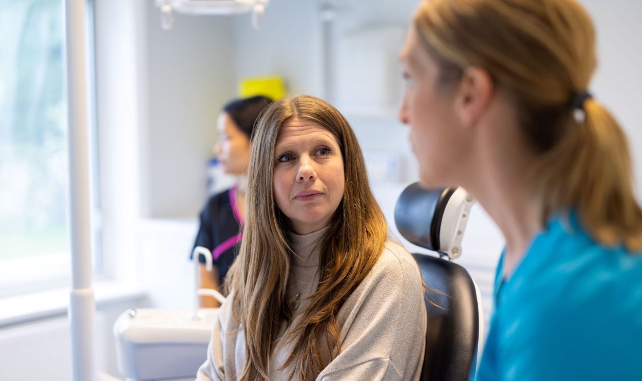 Dentist talking with a patient at Envisage Dental Basingstoke